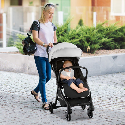 Grey lightweight folding baby stroller for easy travel, ideal for childrens outings.