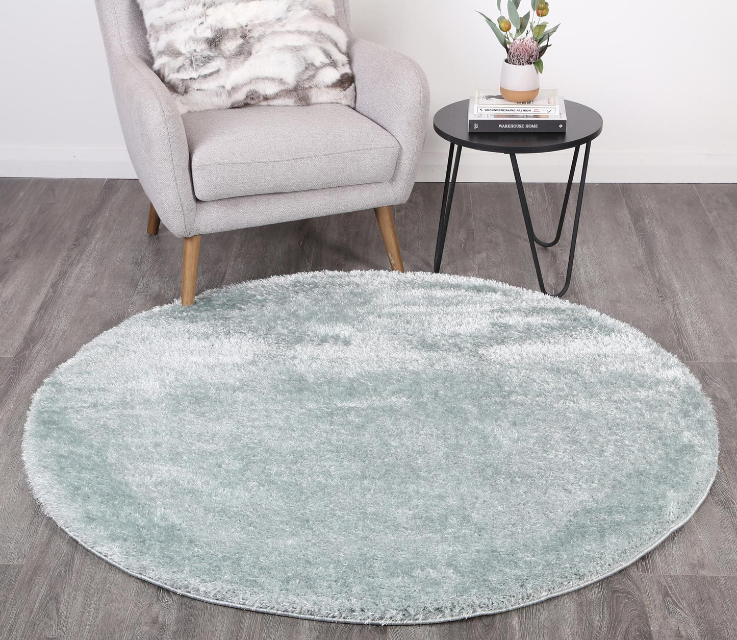 Teal shaggy round rug with soft, fluffy texture for cozy play area in kids room.