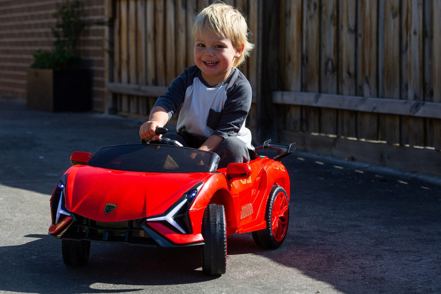Kids electric ride-on car with classic supercar design for indoor/outdoor play. Battery-operated fun.