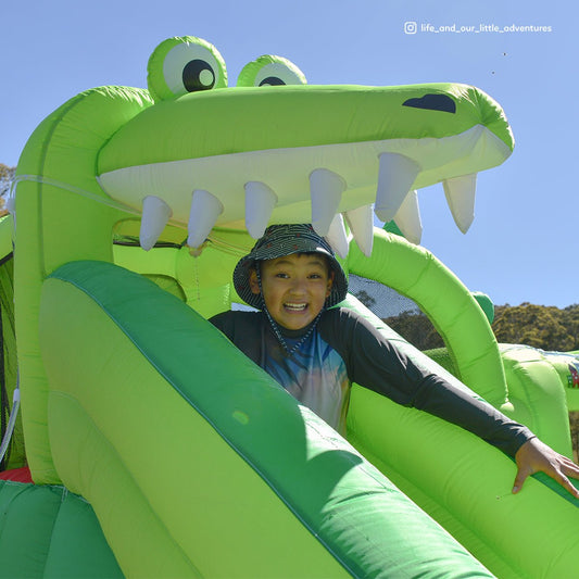 Inflatable water slide with splash pool for backyard fun, ideal for kids playtime.