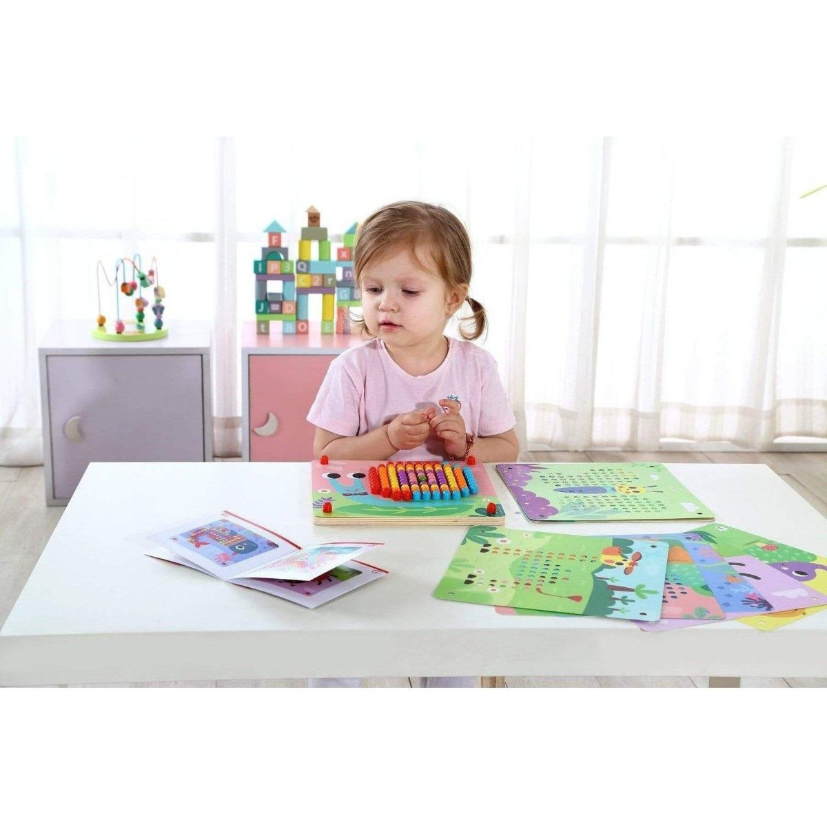Colorful peg board game for kids, promoting pattern recognition and fine motor skills at home. Colorful peg board game for kids, promoting pattern recognition and fine motor skills at home.