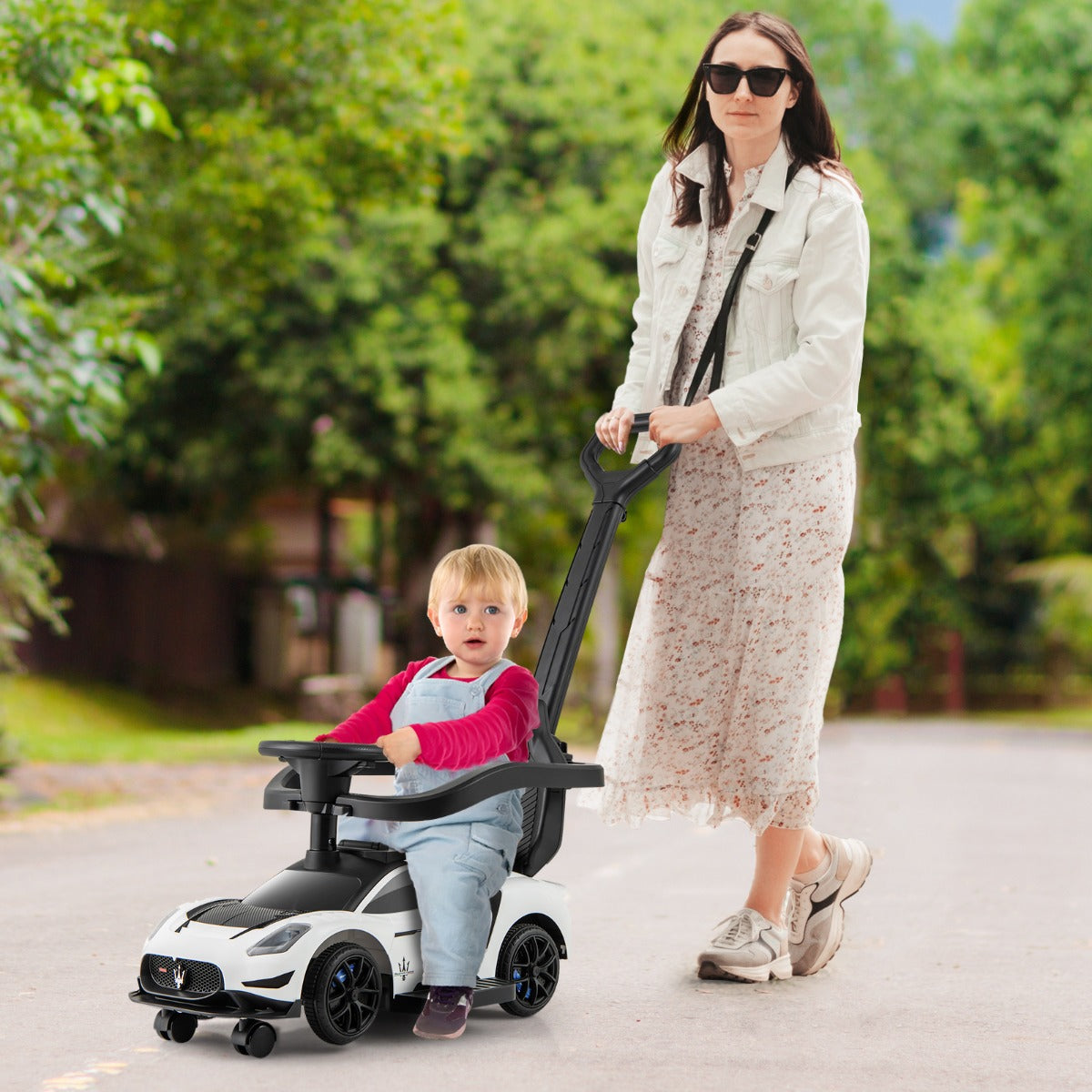 White Maserati-style ride-on push car with musical steering wheel for interactive playtime and stylish cruising.