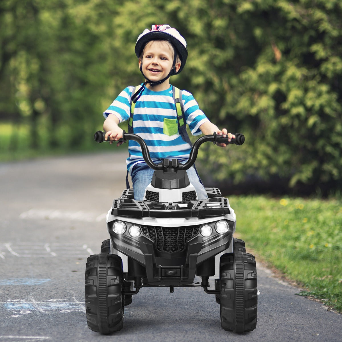 Kids white electric ATV ride-on quad with music player for indoor/outdoor play.