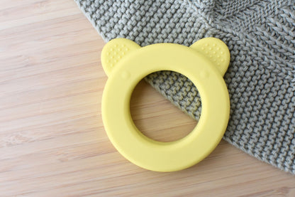 Yellow Bear Silicone Teether with Rattle for soothing teething, ideal for infants.