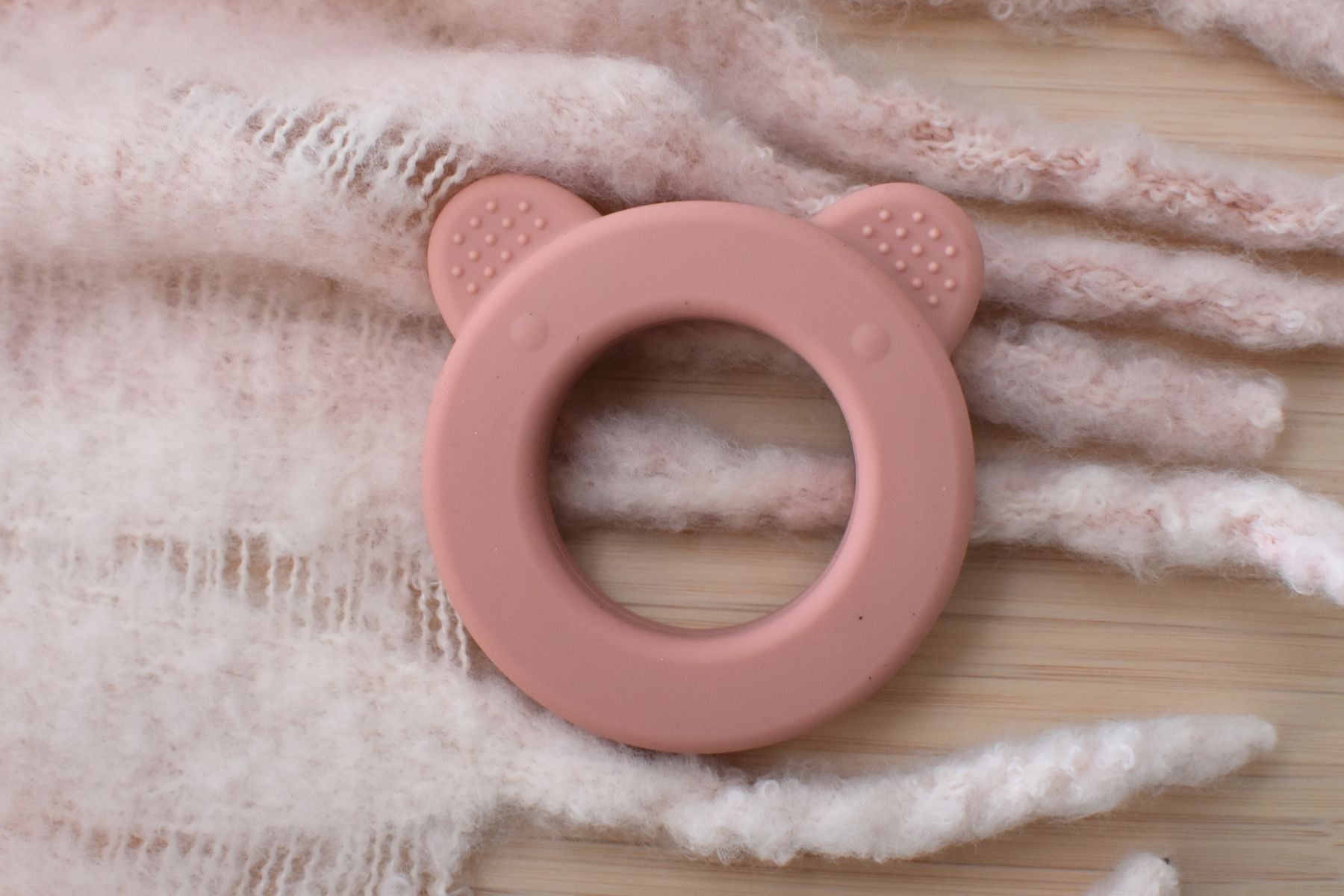 Pink Bear Silicone Teether with Rattle for soothing teething discomfort, ideal for babies.