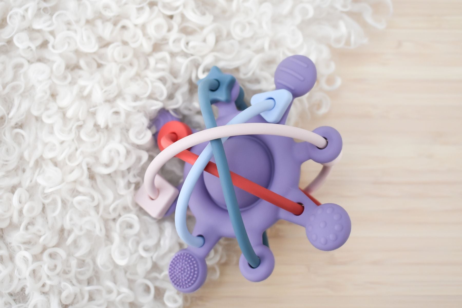 Koala Dream Purple Silicone Teether Rattle - Textured sensory toy for soothing teething discomfort.