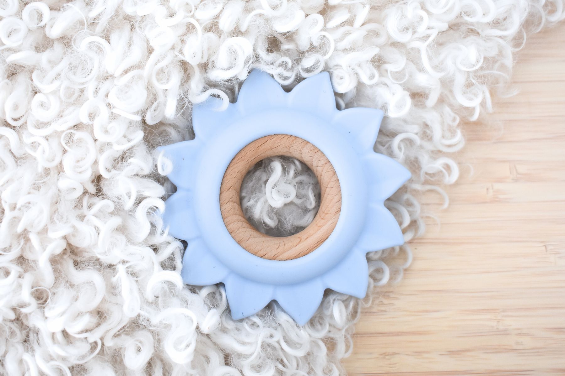 Blue Sunflower Teether for Babies made of silicone & wood for soothing.