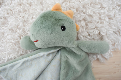 Soft mint dinosaur teether blanket for babies, providing comfort and relief during teething.