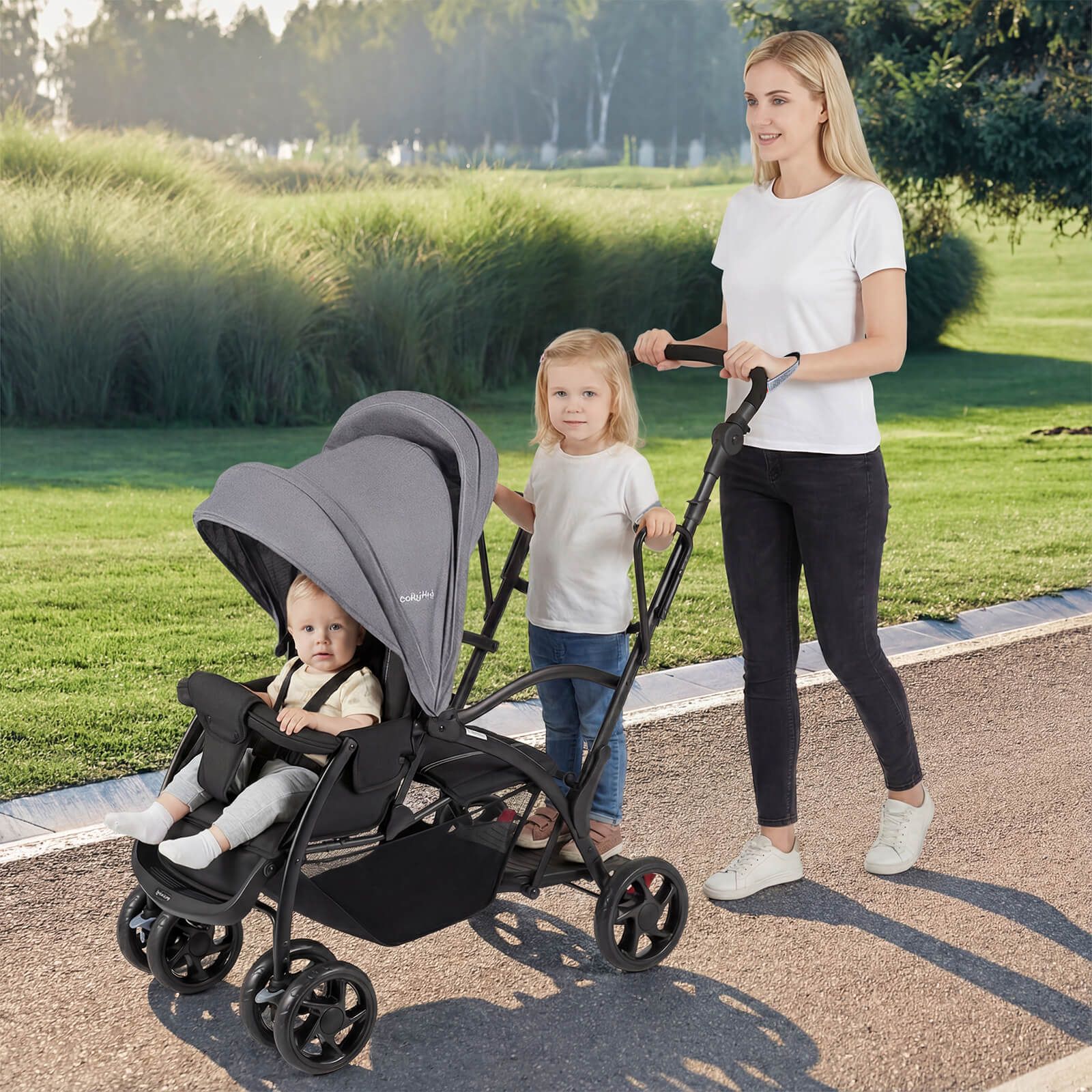 Woman pushing a stroller with two children in a park