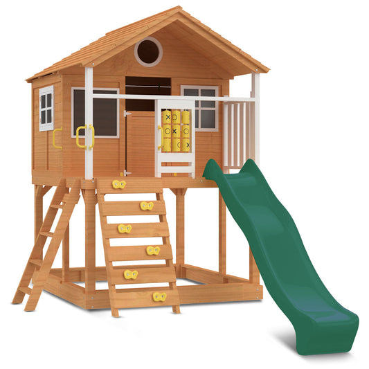 Warrigal beach-themed cubby house features a green slide and vibrant coastal design for outdoor play adventures.