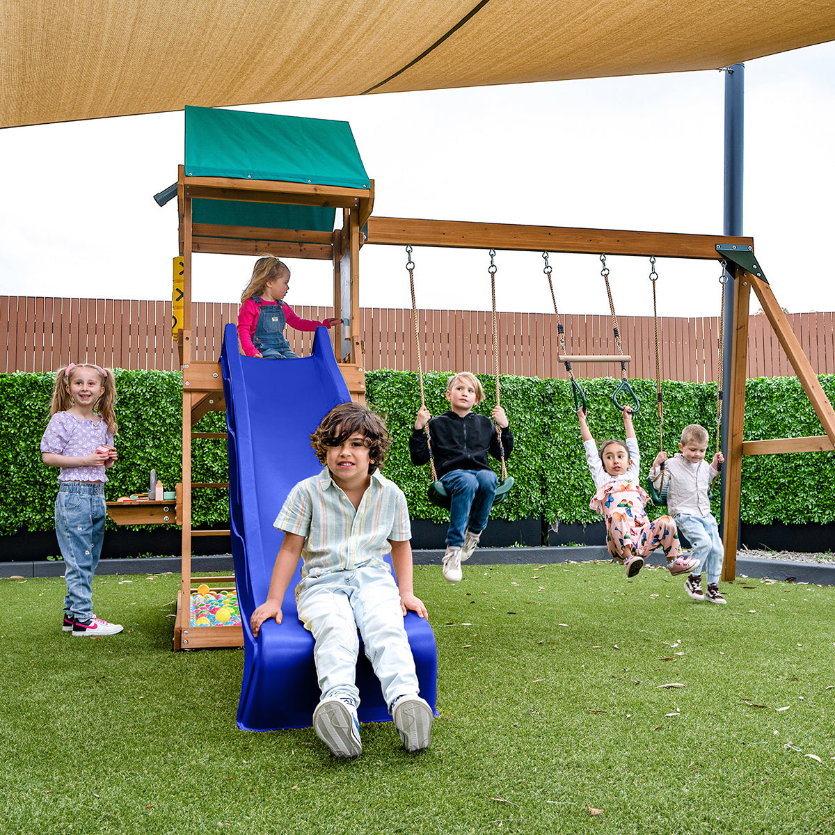 Birmingham outdoor play set featuring swings and a blue slide for childrens backyard fun and exercise.