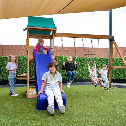 Birmingham outdoor play set featuring swings and a blue slide for childrens backyard fun and exercise.