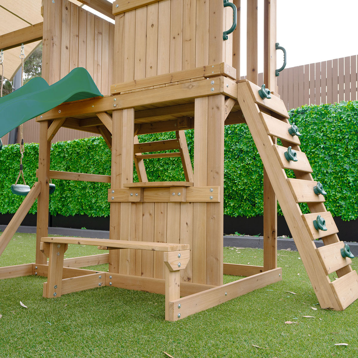 outdoor playground set featuring swings and a green slide for active backyard fun and adventure.