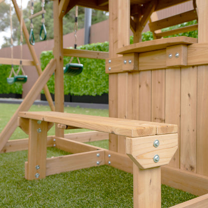 outdoor playground featuring a Carindale play structure with multiple swings and an exciting green slide for.