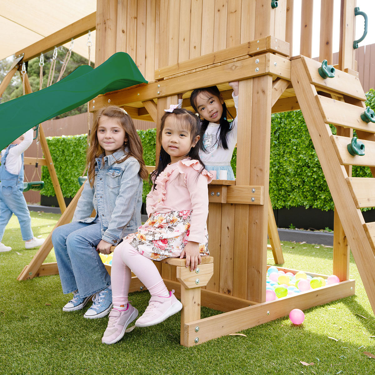 Children playing on Carindale playset with hideaway and bench