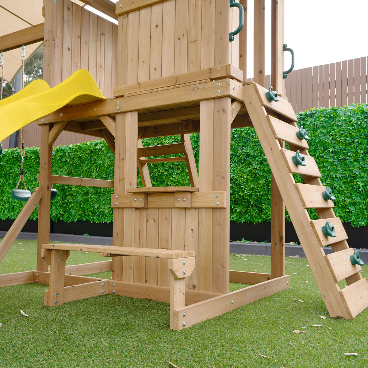 outdoor playground set featuring swings and a yellow slide for active backyard fun and adventure.