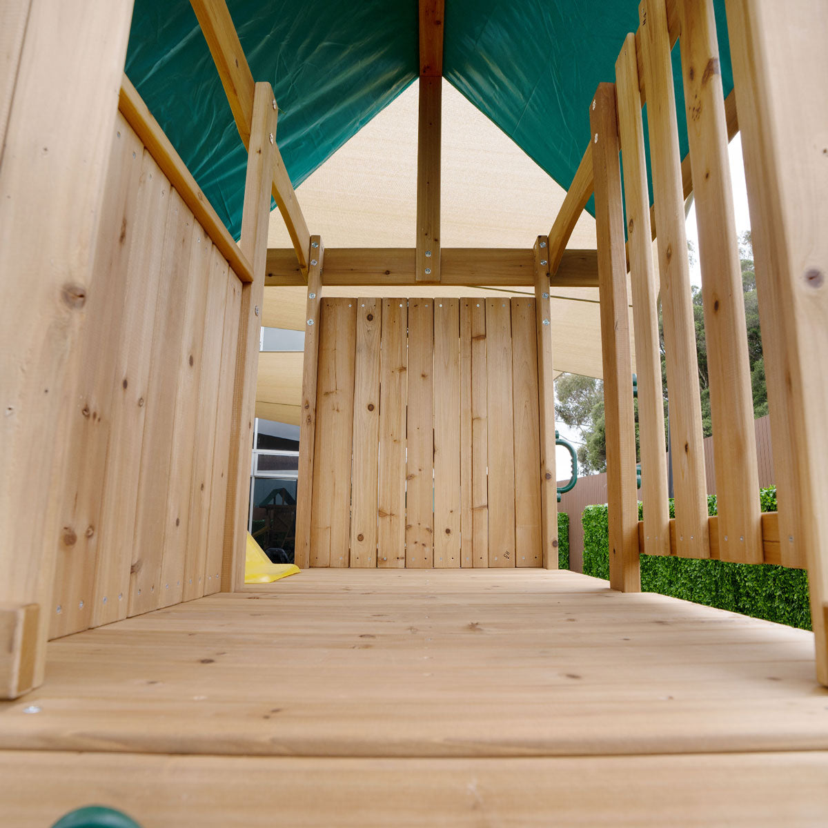 Carindale playground featuring swings and a yellow slide for outdoor fun and active play.