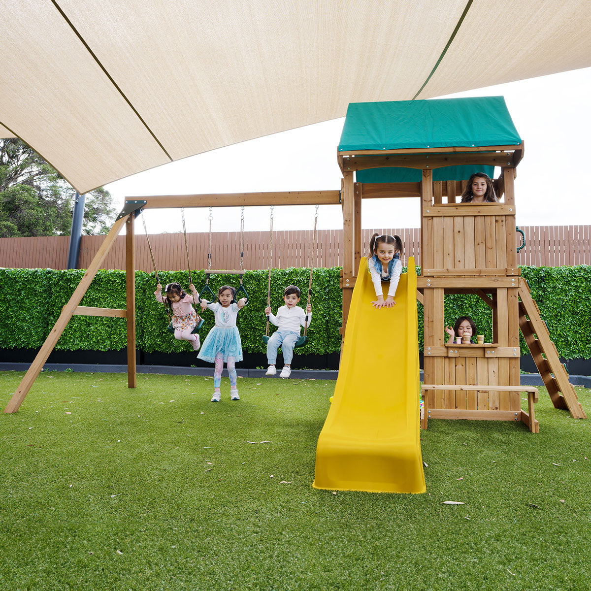 Carindale playground set featuring swings and a yellow slide for outdoor fun and active play.