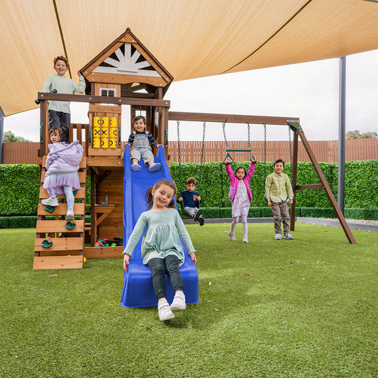 Coventry outdoor play set features blue slide, swings, and climbing wall for active backyard adventures.