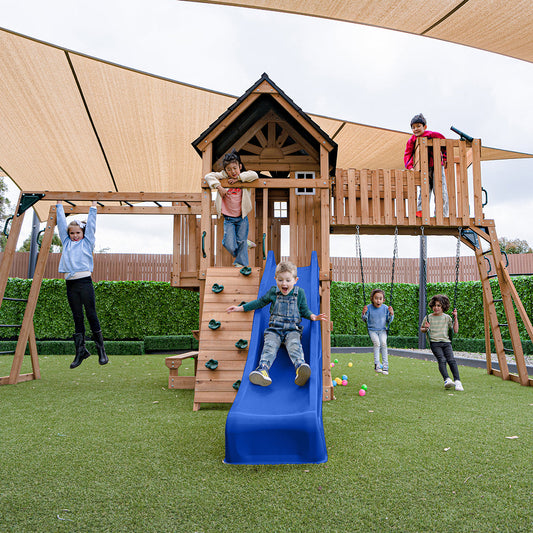 Kensington adventure playground featuring a vibrant blue slide and multi-activity play center for outdoor fun and exercise.