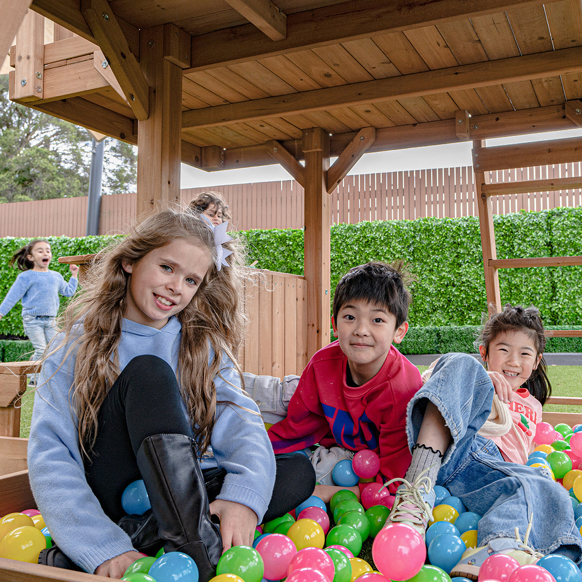 Kensington outdoor playset features a towering green slide and multiple activity stations for adventurous backyard fun.