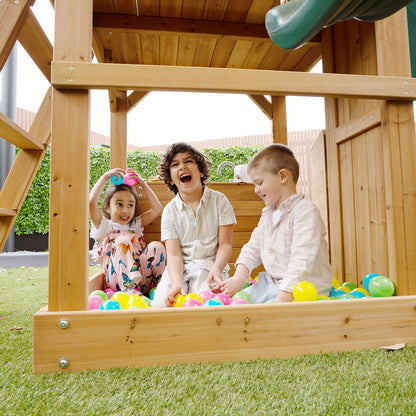 Montrose outdoor play set featuring a tall green slide, promoting active play and outdoor adventures.