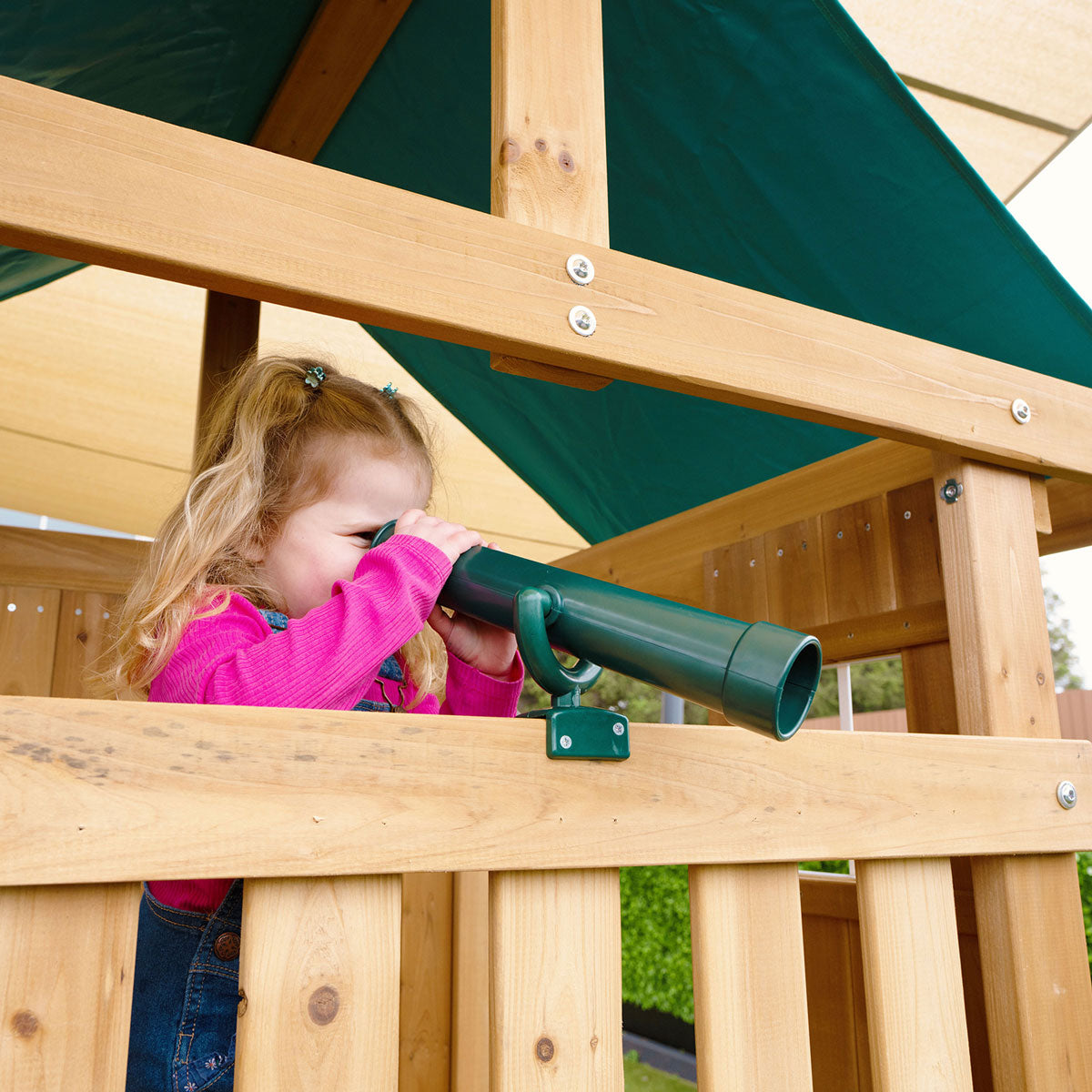 Montrose outdoor play set featuring a tall green slide, perfect for backyard adventures and active playtime.