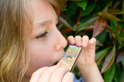 Colorful wooden bee-shaped harmonica toy encourages musical exploration and fine motor skills development through playful