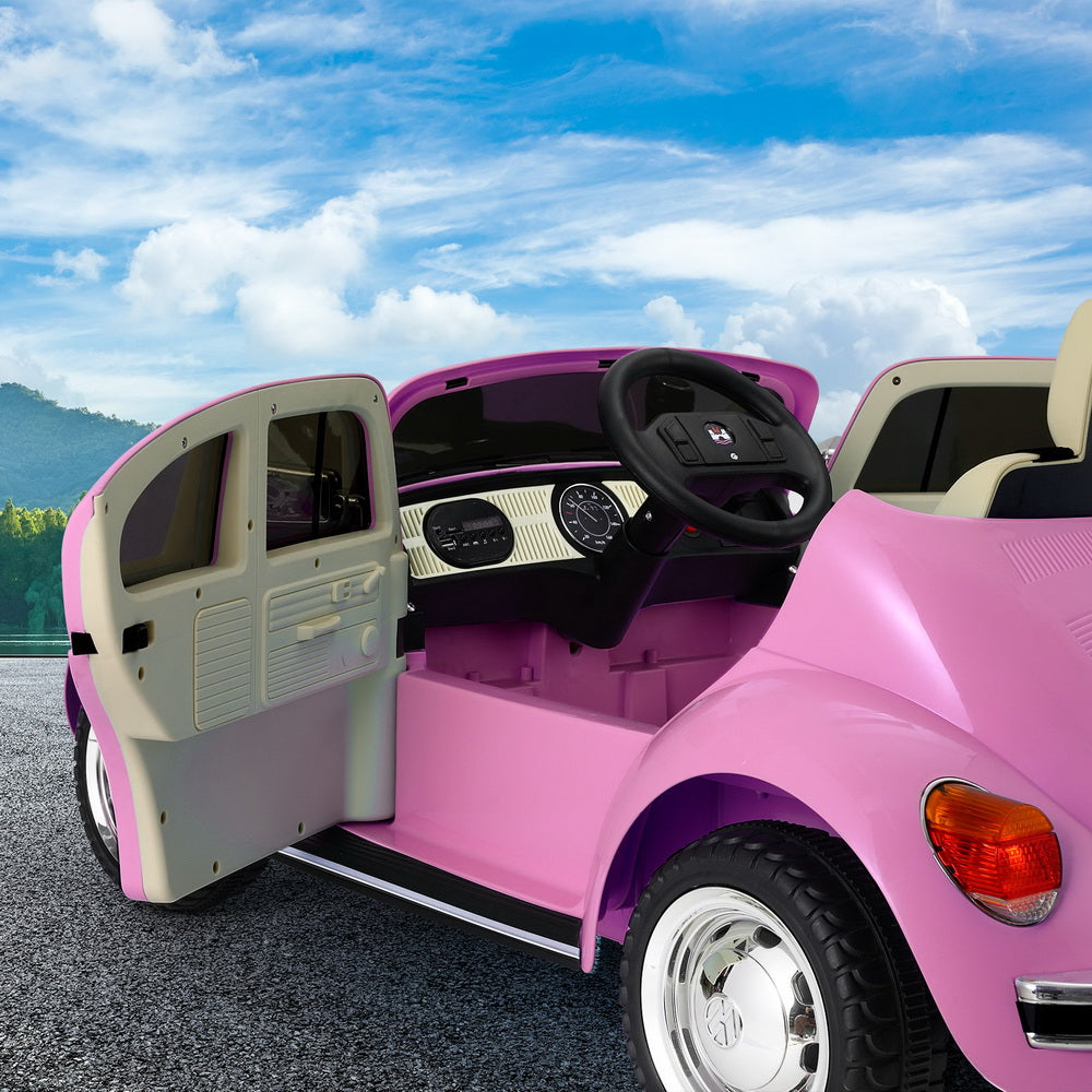 Adorable pink Volkswagen Beetle kids ride on car with remote control, perfect for home play.