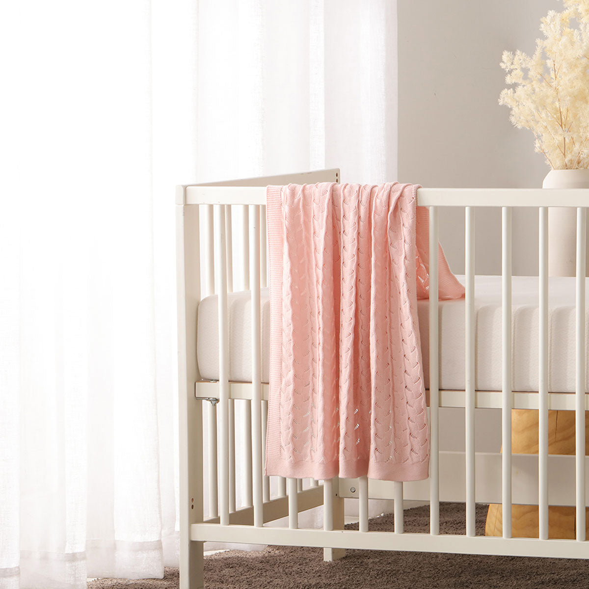 Organic cotton baby blanket in Lyla Blush, soft and safe for cozy home snuggles.
