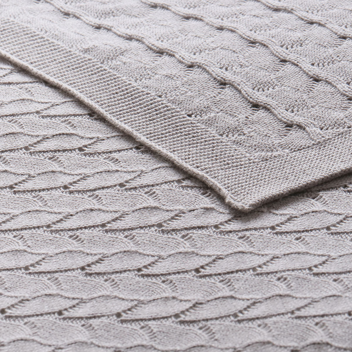 Organic grey baby blanket made of soft cotton for cozy and safe use.