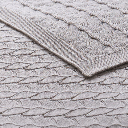 Organic grey baby blanket made of soft cotton for cozy and safe use.