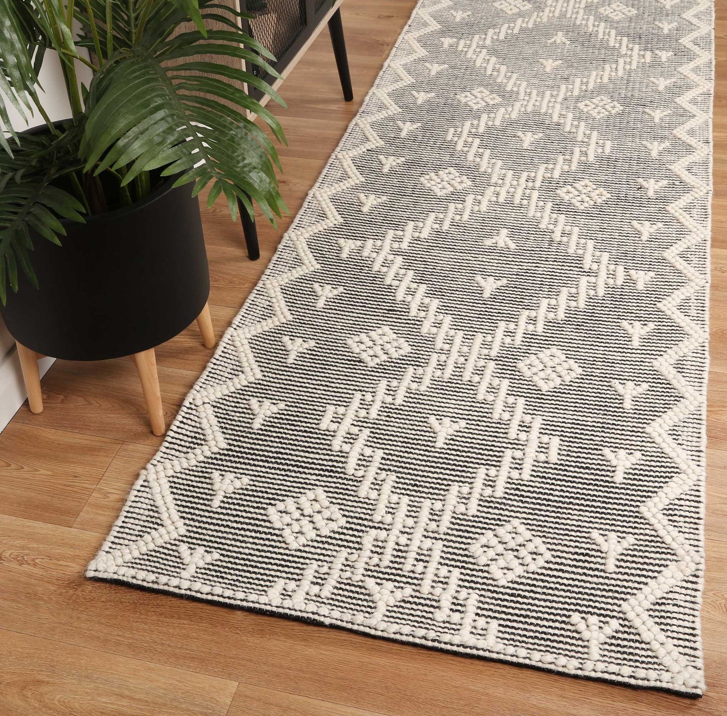 Colorful tribal geometric rug with cream tones, ideal for childrens playroom or bedroom.