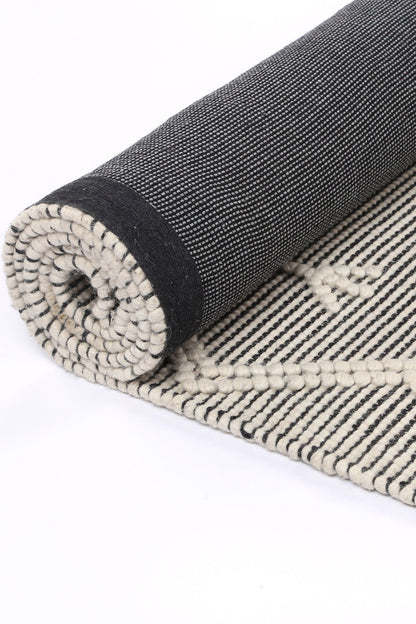 Geometric cream wool rug, 300x400cm, ideal for kids rooms with a tribal design touch.
