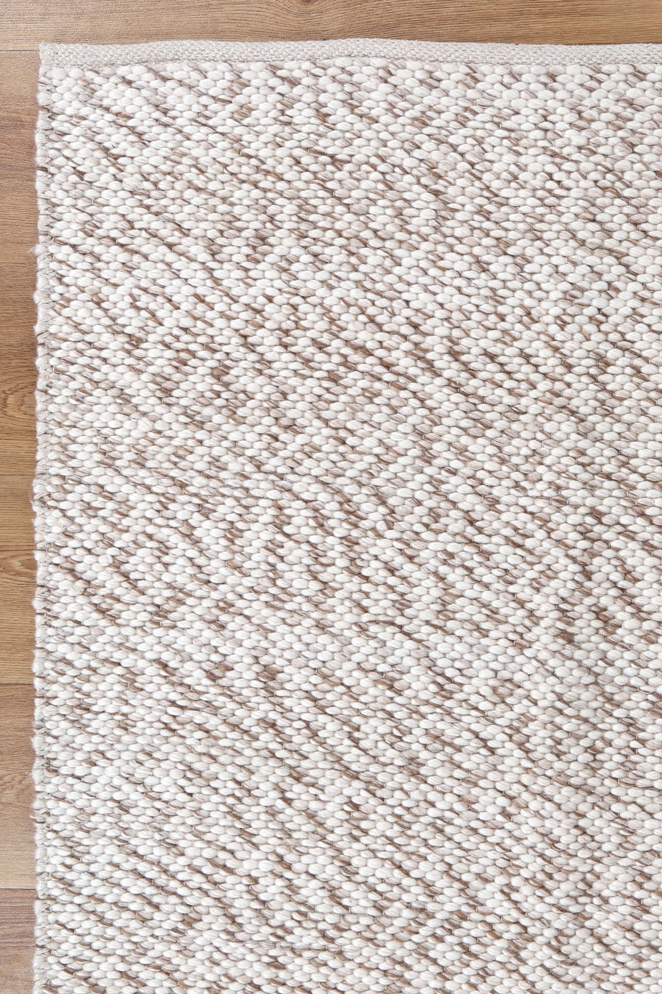 Beige wool rug with hand-braided design, ideal for childrens room decor, 160x230cm size.