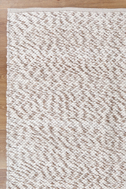 Beige wool rug with hand-braided design, ideal for childrens room decor, 160x230cm size.