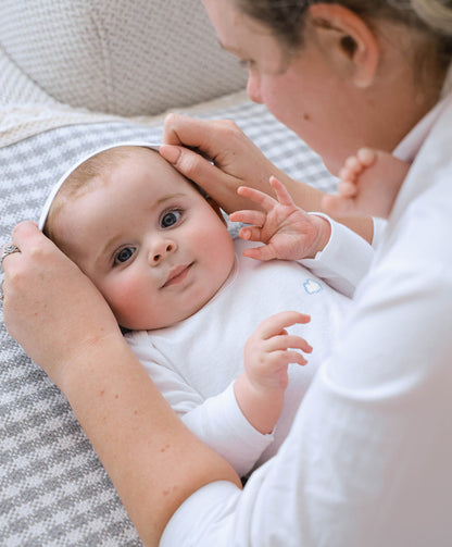 6-piece newborn essentials pack in pure white organic cotton for babys comfort and care.