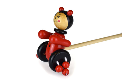 Colorful wooden ladybird push toy for toddlers, ideal for early walking practice at home.