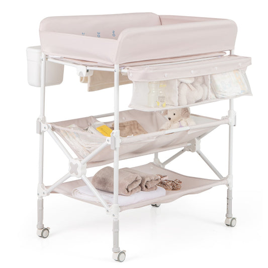 Wheeled beige diaper station folds for portability, offering a waterproof surface for on-the-go changes.