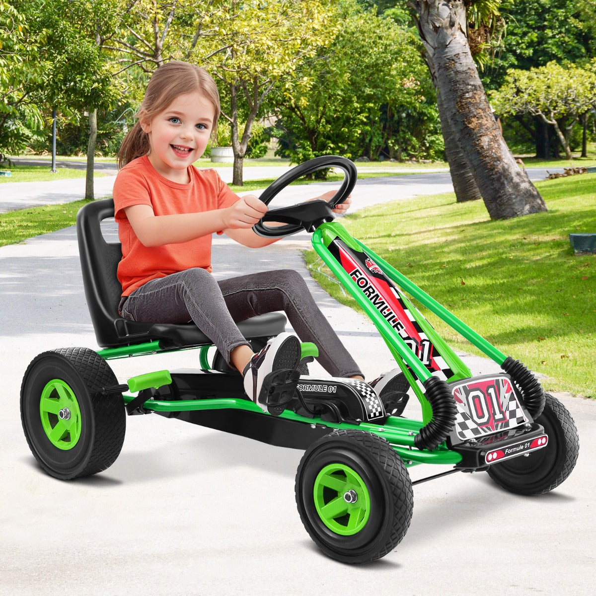 Green kids pedal go kart with adjustable steering wheel for backyard adventures.