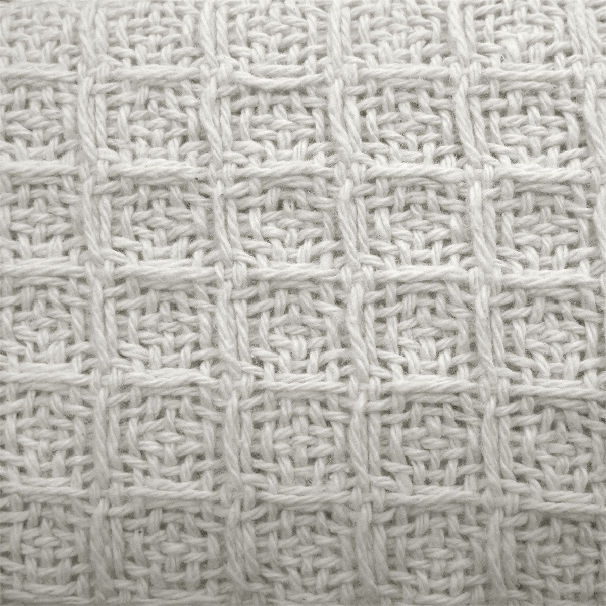 Soft, white cotton waffle blanket designed for kids beds, offering cozy and comforting warmth.