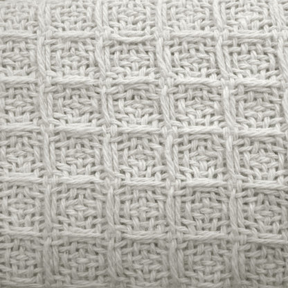 Soft, white cotton waffle blanket designed for kids beds, offering cozy and comforting warmth.