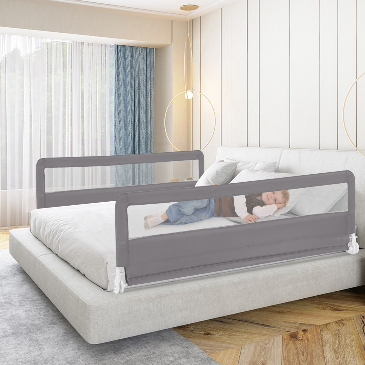 Foldable toddler bed rail in grey, with safety straps for a secure sleep environment.