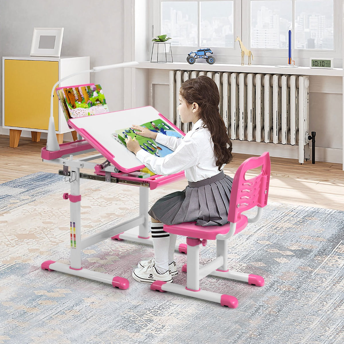 Adjustable pink study desk and chair set with LED light for childrens learning environment.