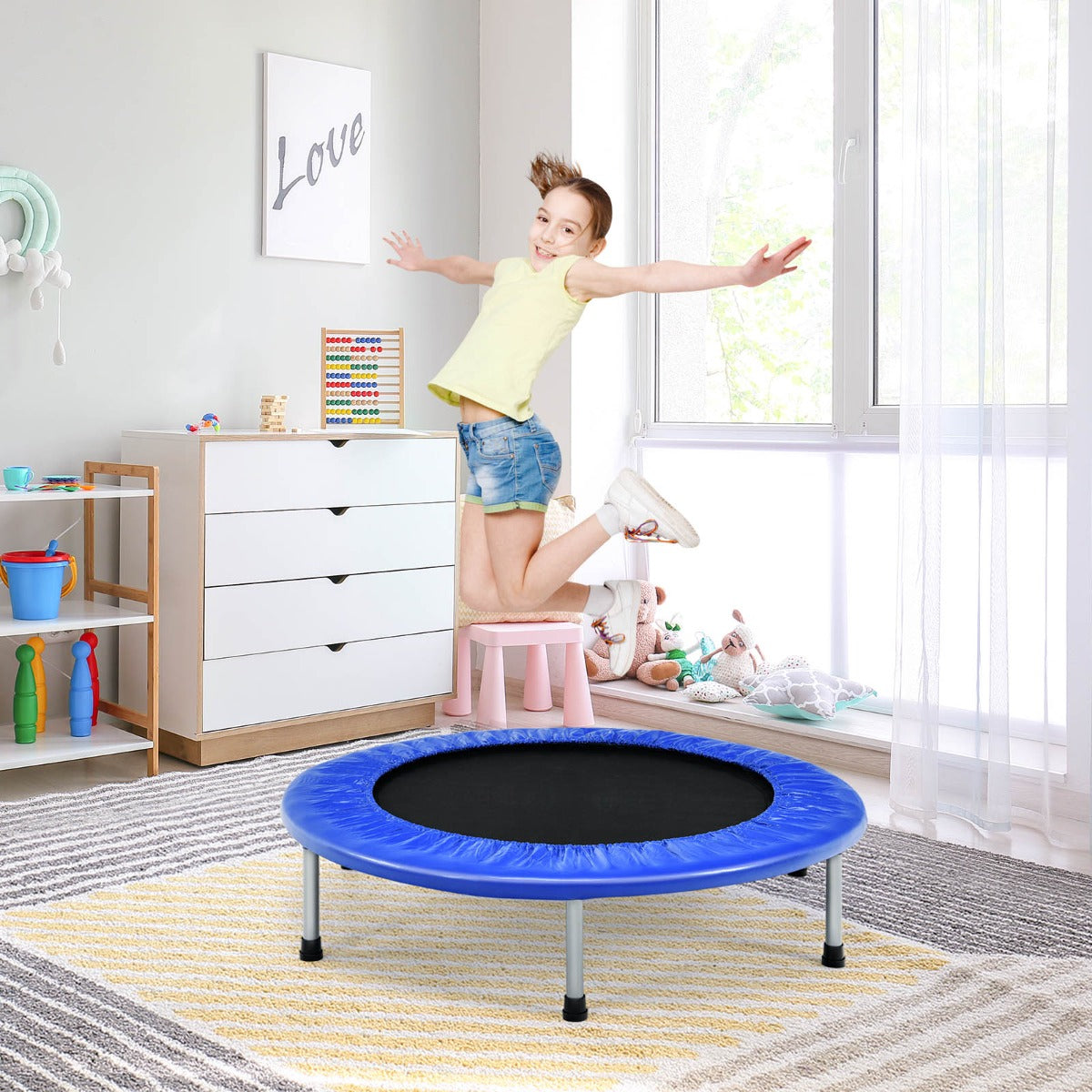Kids blue portable folding trampoline with safety cover, ideal for indoor active play.