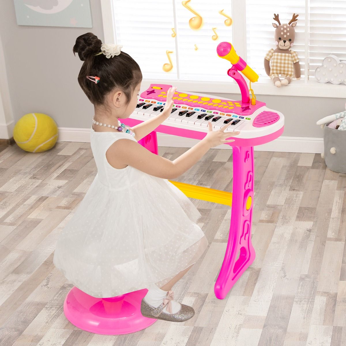 Pink electronic keyboard for children features 31 keys and includes a matching stool for musical play