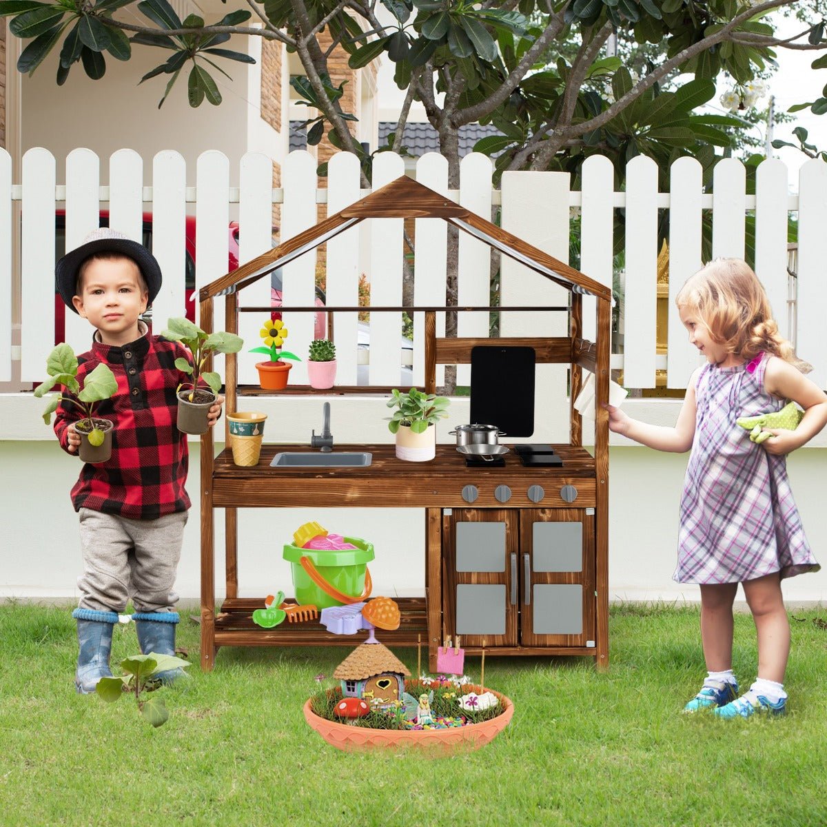 Kids outdoor wooden mud kitchen playset with storage for creative backyard play.