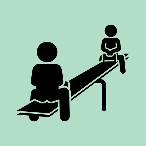 Two kids playing on a seesaw in a playground