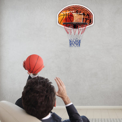 Indoor wall-mounted basketball backboard with net for childrens play, ideal for home playrooms.