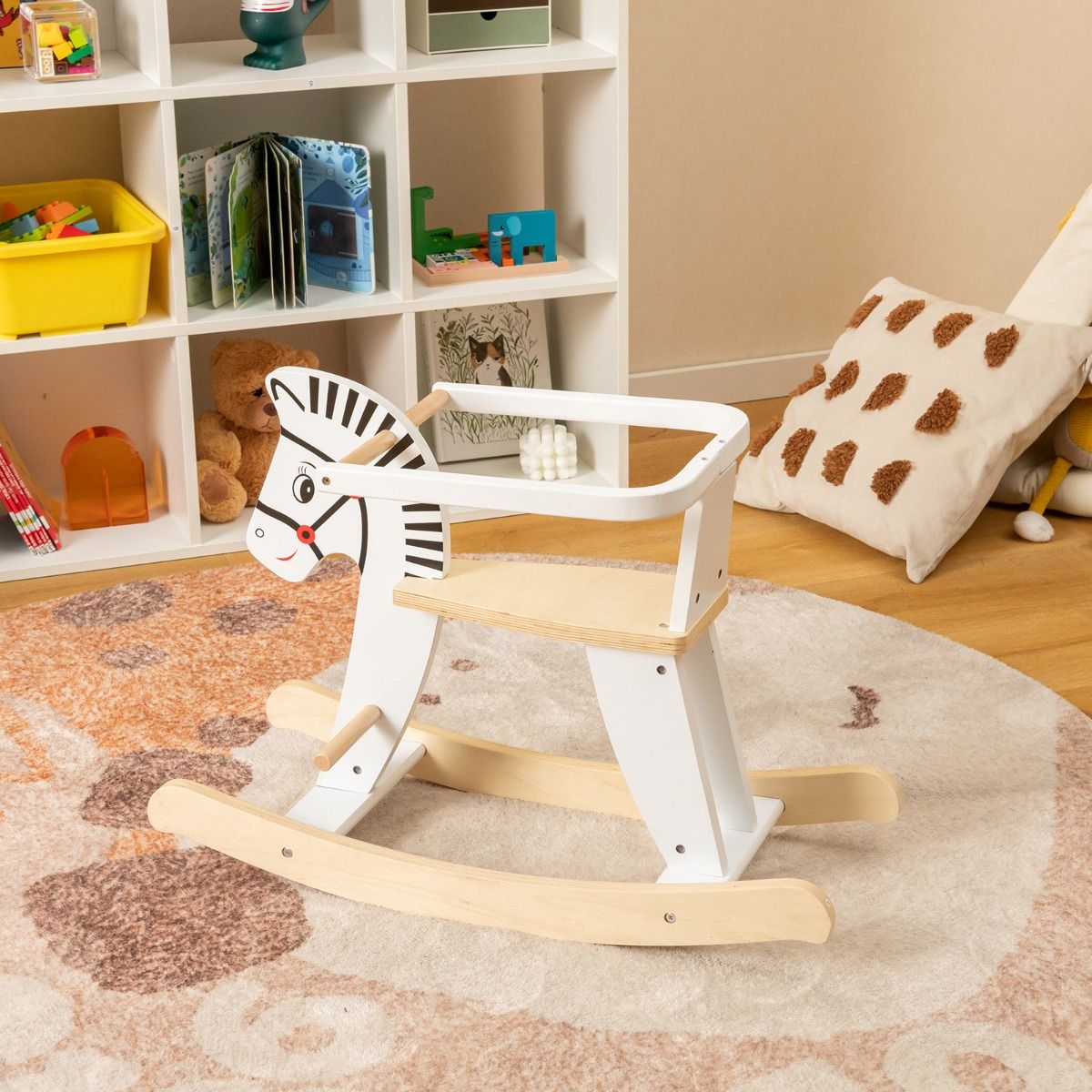 White wooden rocking horse with safety fences for kids playtime and room decor.